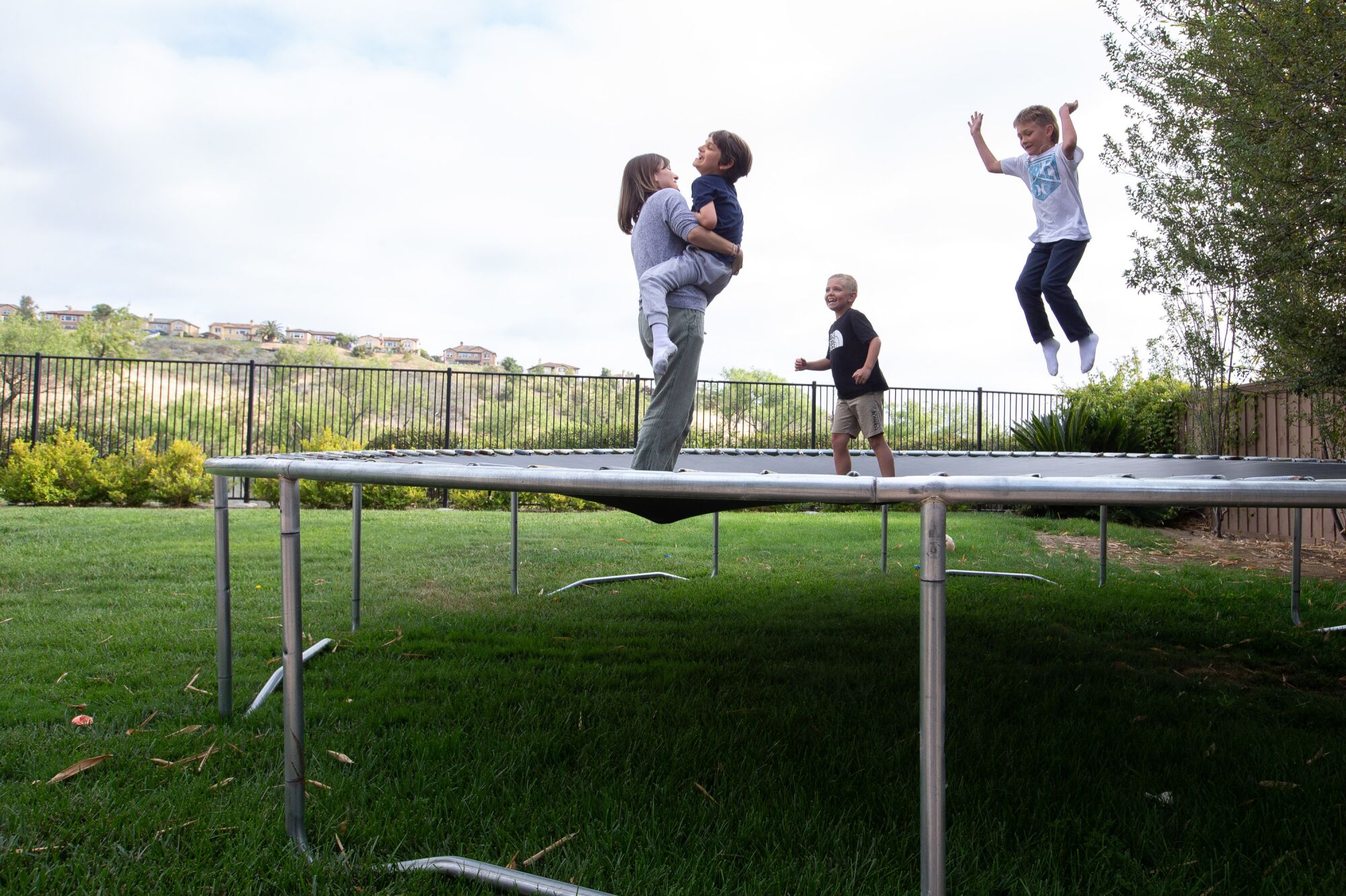 Kelley Dalby holds her son Connor for some trampoline time