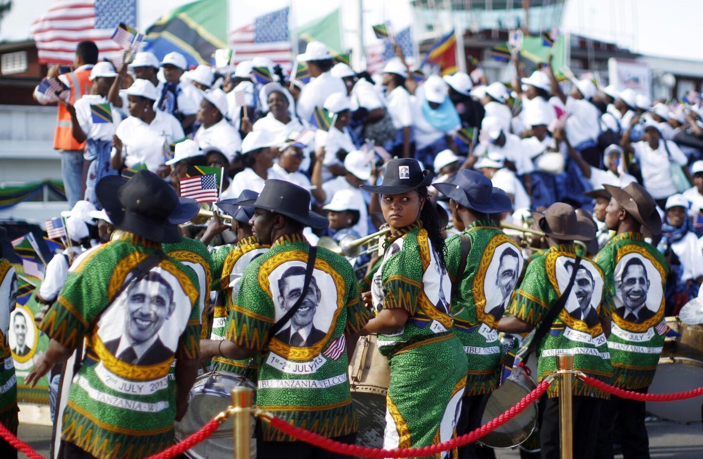 A Tanzanian band wear outfits featuring image of U.S. President Obama during an official arrival ceremony in Dar es Salaam