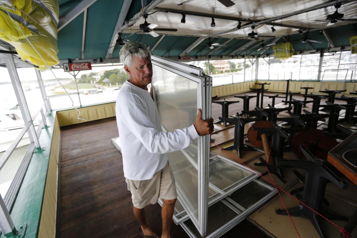 Bob Wilder, an employee at Morgan Creek Grill, moves windows from the third floor bar at the popular restaurant on the Isle of Palms, S.C., Wednesday in advance of Hurricane Matthew.