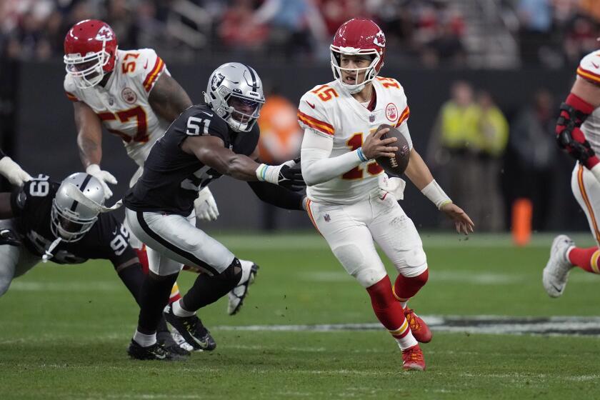 Chiefs quarterback Patrick Mahomes scrambles away from Raiders defensive end Malcolm Koonce (51) on Jan. 7, 2023.