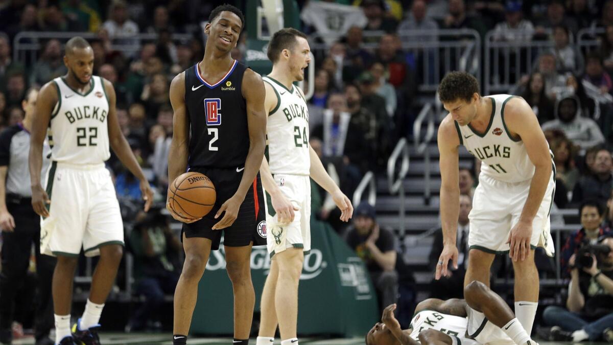 The Clippers' Shai Gilgeous-Alexander (2) reacts after fouling the Milwaukee Bucks' Eric Bledsoe, bottom right, in the second half
