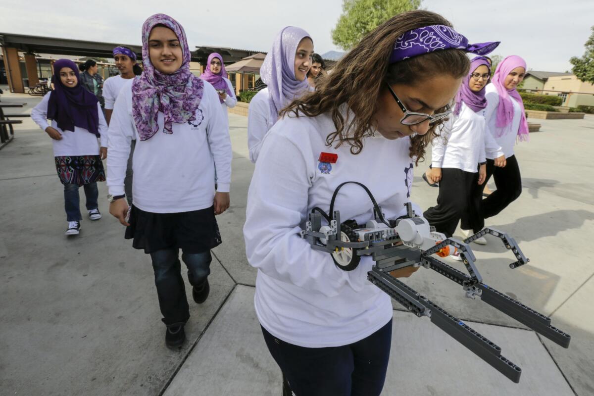 FemSTEM team member Salma Rashad tests one of the attachments on the way into competition.