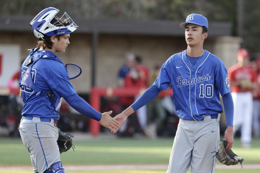 SAN DIEGO, CA - MARCH 28, 2024: Rancho Bernardo pitcher Mason Garris shakes hands with catcher Josh Hartman at the end of the fifth inning of the Lions Tournament Open Division final against Cathedral Catholic at Cathedral Catholic High School in San Diego on Thursday, March 28, 2024. (Hayne Palmour IV / For The San Diego Union-Tribune)