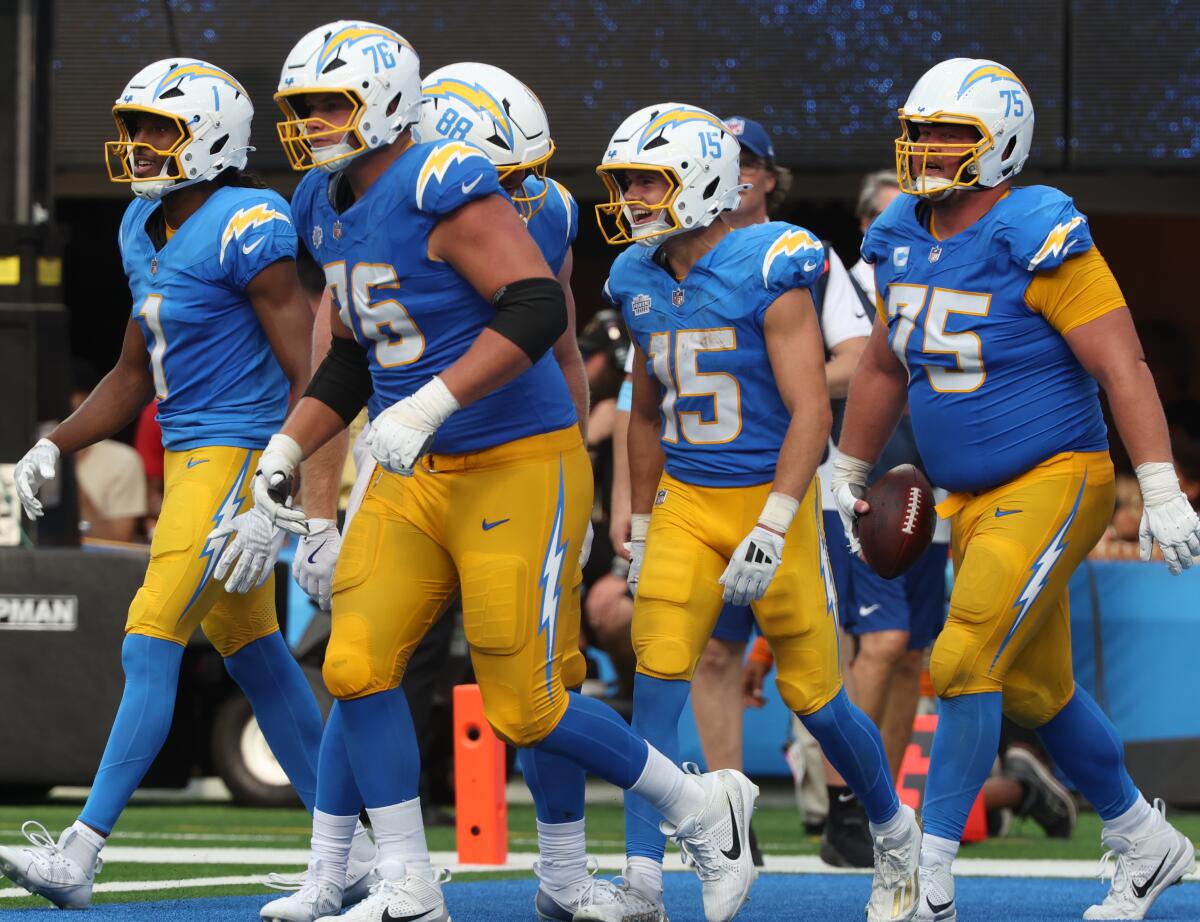  Chargers wide receiver Ladd McConkey (15) celebrates with teammates after his touchdown catch against the Raiders. 