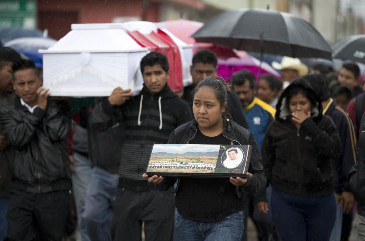 Mourners carry the coffin of Jesus Cadena Sanchez through Nochixtlan, where eight people died in June during a confrontation between police and protesting teachers who blockaded a roadway. (Eduardo Verdugo / Associated Press)
