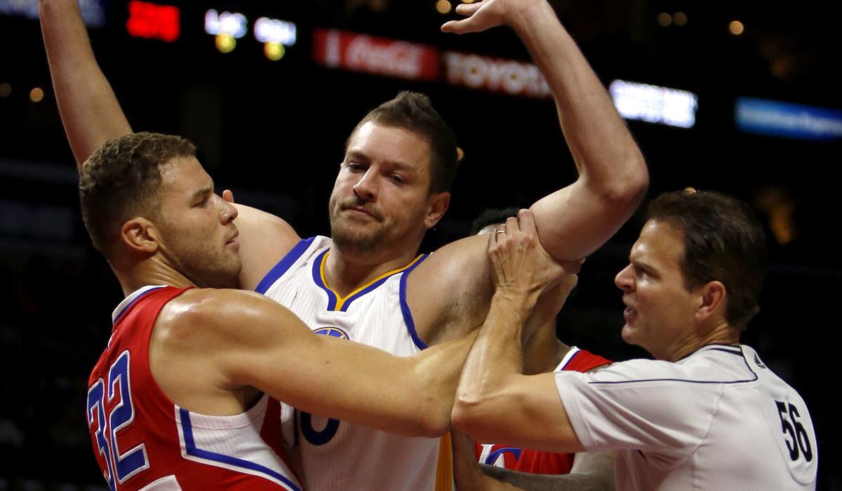 Power forwards Blake Griffin (32) of the Clippers and David Lee of the Warriors get tangled battling for position in the first half.