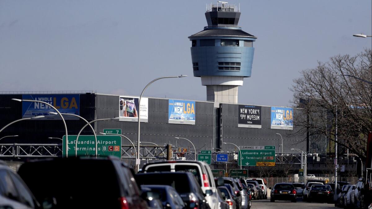 The air traffic control tower at LaGuardia Airport is seen Friday after the Federal Aviation Administration temporarily barred incoming flights in response to a shortage of air traffic controllers.
