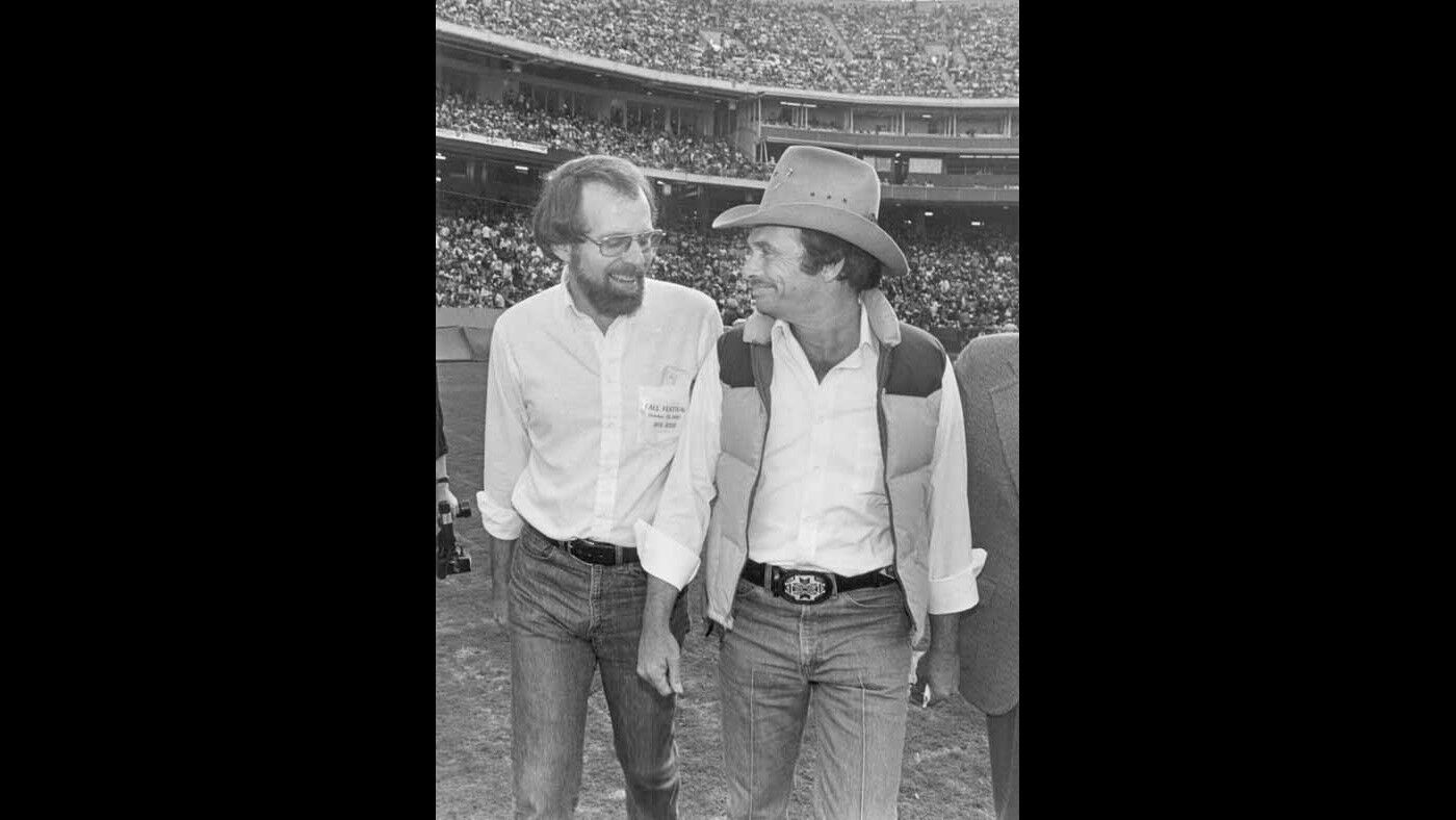 Merle Haggard, right, and then Times writer Robert Hilburn at Anaheim Stadium in October 1980.