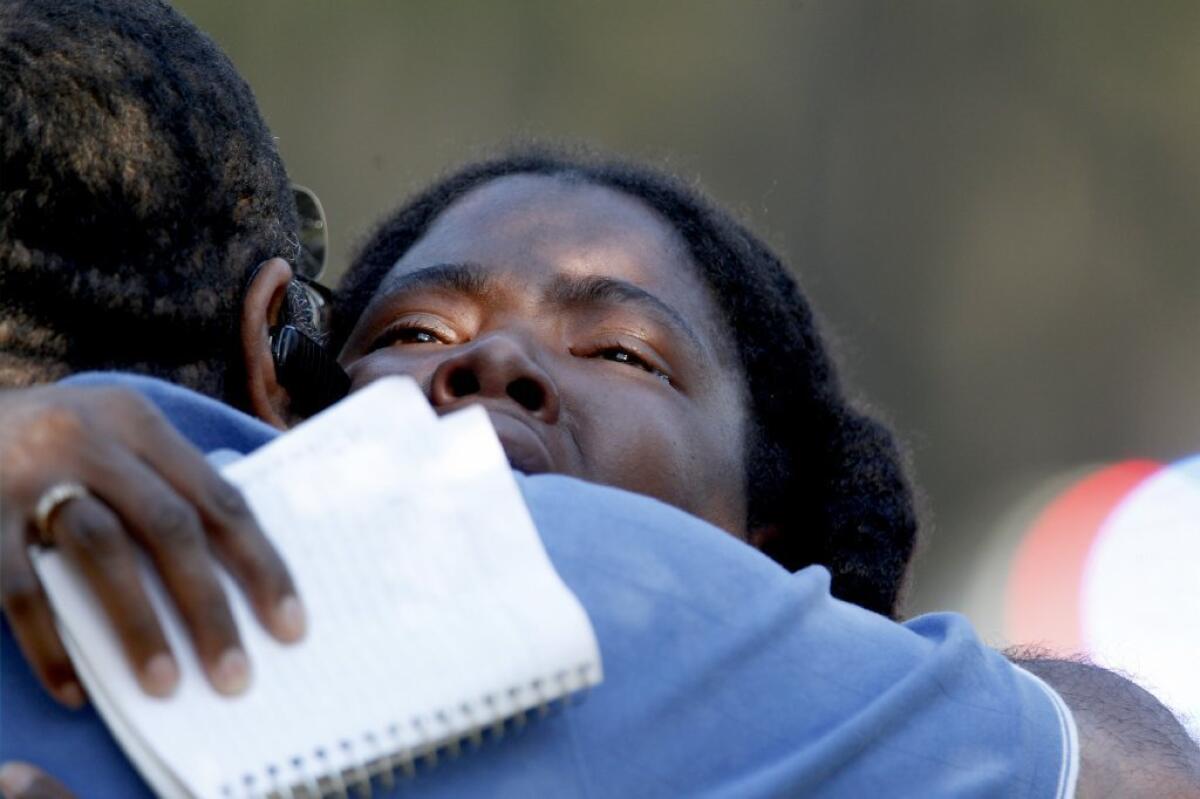 Lone Star College freshman Sheketa Taylor hugs her father Judson Gimblin after they found each other on the Lone Star Campus following Tuesday's shooting.