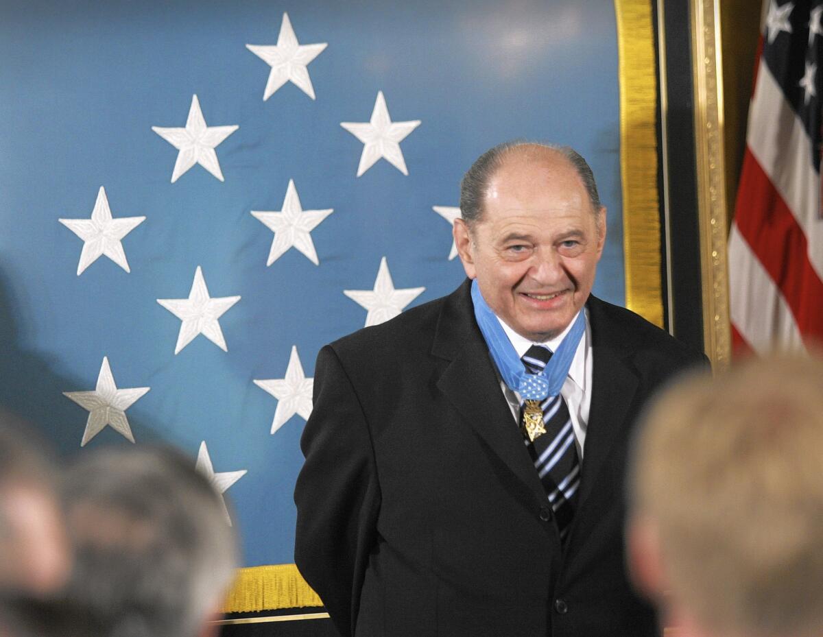 Tibor Rubin receives a standing ovation in the East Room of the White House on Sept. 23, 2005, upon receiving the Medal of Honor from President George W. Bush.