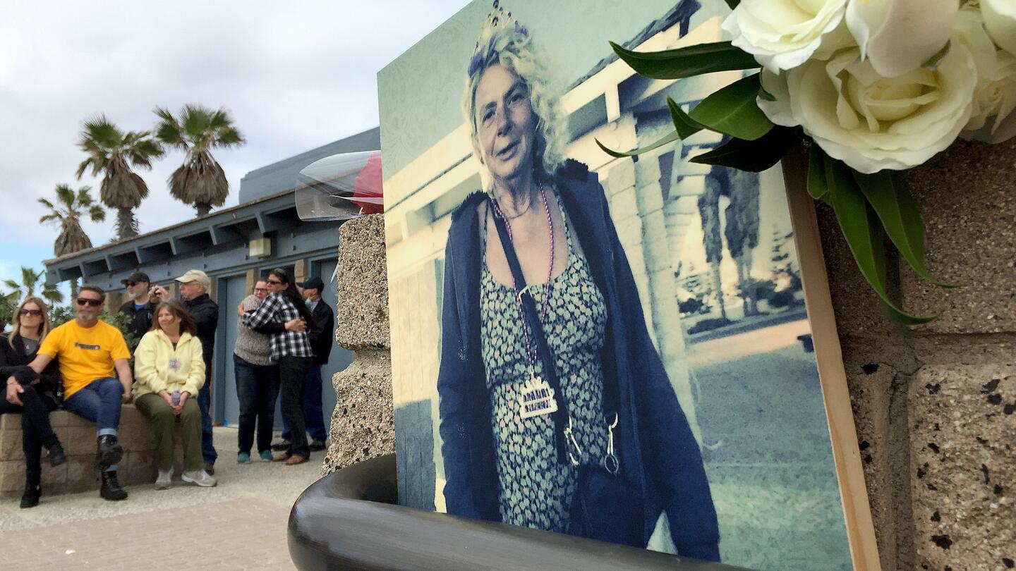 Mourners attend a memorial at Huntington State Beach for local homeless woman, Ann "Annie" Bonelli, 56, who was killed by a minivan driver while crossing Pacific Coast Highway at Newland Street Tuesday evening in Huntington Beach.