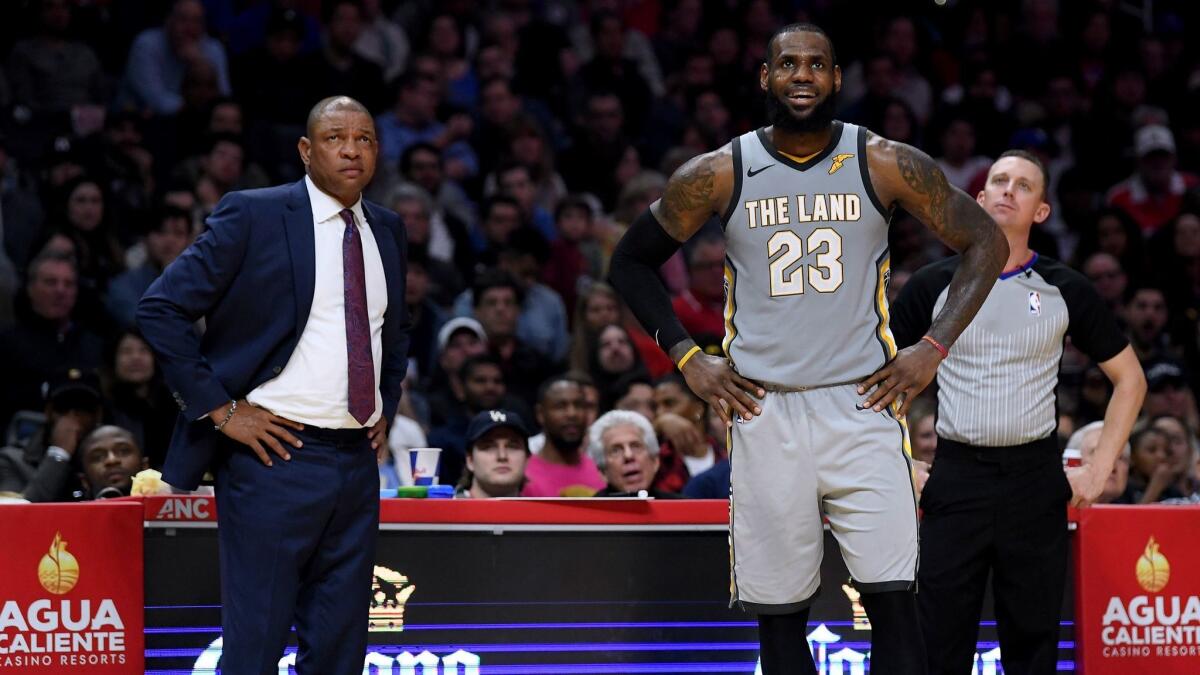 LeBron James of the Cleveland Cavaliers and Doc Rivers react to a free throw during a 116-102 Clipper win at Staples Center on March 9, 2018 in Los Angeles.