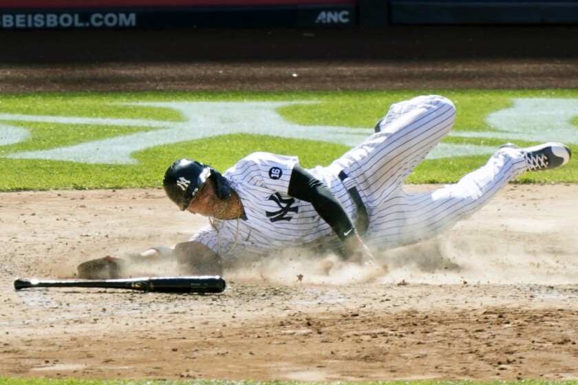 New York Yankees' Gleyber Torres slides home to score on a single by Aaron Hicks in the eight inning of a baseball game against the Houston Astros, Thursday, May 6, 2021, at Yankee Stadium in New York. The Astros defeated the New York Yankees 7-4. (AP Photo/Kathy Willens)