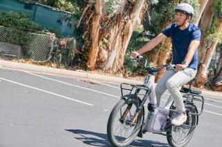 ALSO president Chris You rides on an e-bike at the ALSO headquarters.