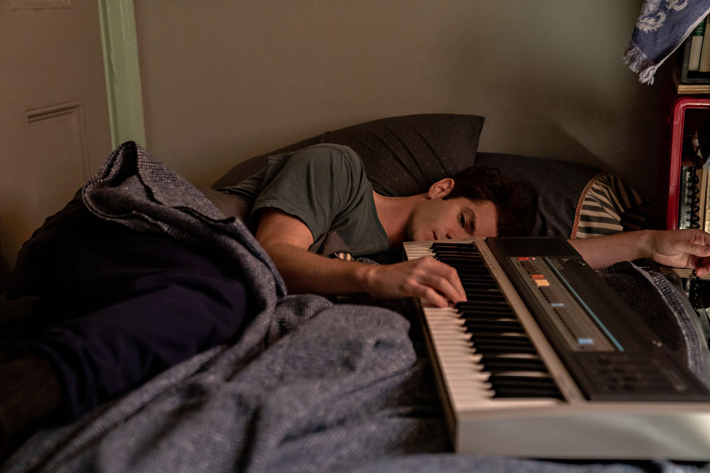 A man asleep next to a keyboard