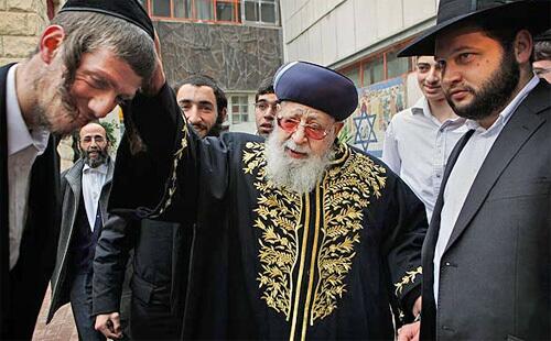 Rabbi Ovadia Yosef, center, the Jewish spiritual leader of Israel's Shas party, blesses a man after casting his ballot at a polling station in Jerusalem during Tuesday's election. The two front-runners in the race to rule Israel made last-minute appeals to voters as polls opened in a close general election whose outcome could determine the course of Mideast peace negotiations.