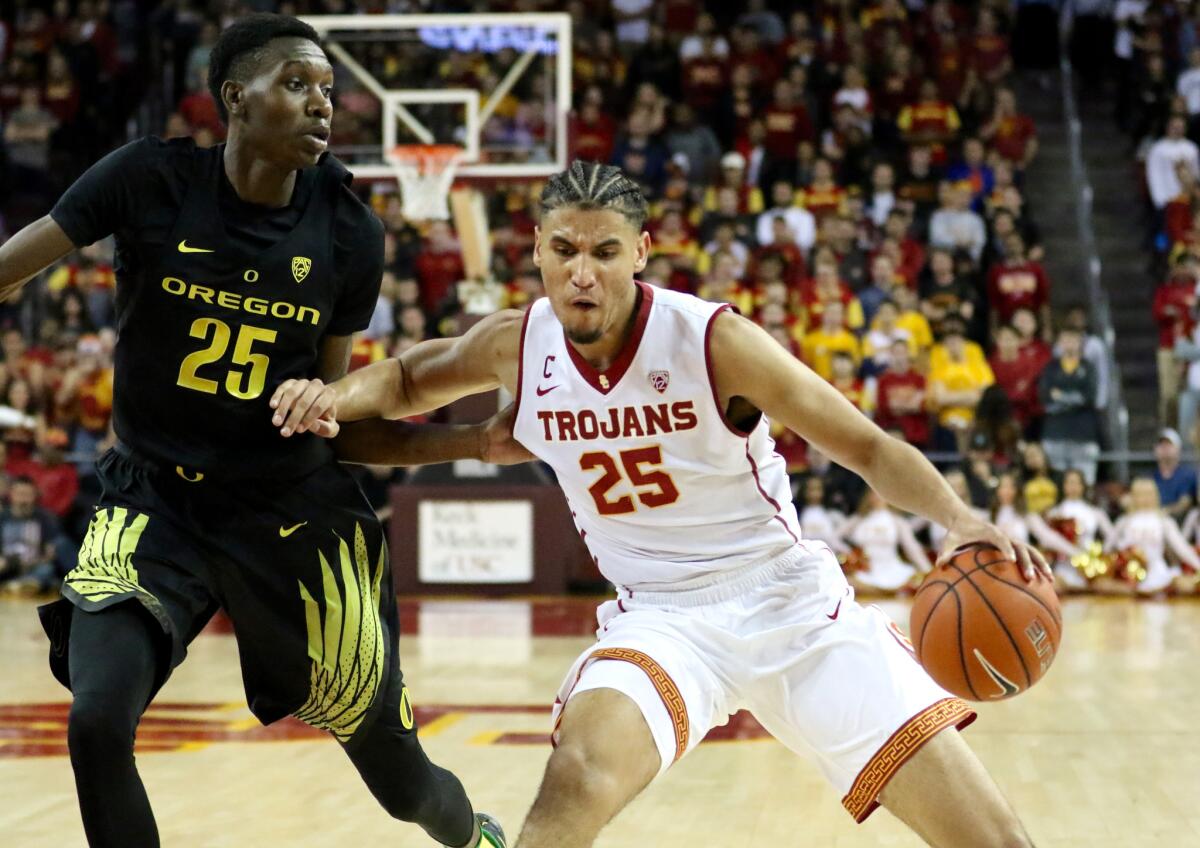 USC forward Bennie Boatwright tries to drive against Oregon forward Chris Boucher in the second half on Feb. 11.