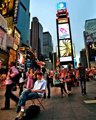 Tourists flock to Time Square night and day.