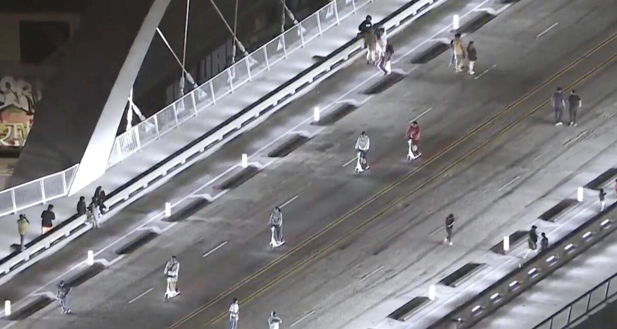 People on the 6th Street Viaduct on foot and on scooters