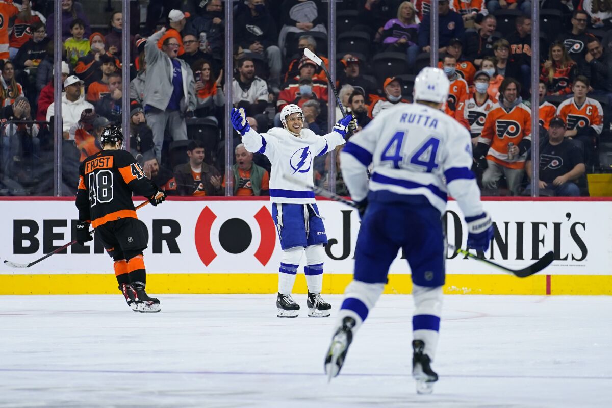 Tampa Bay Lightning's Mathieu Joseph, center, reacts after scoring a goal during the second period of an NHL hockey game against the Philadelphia Flyers, Sunday, Dec. 5, 2021, in Philadelphia. (AP Photo/Matt Slocum)