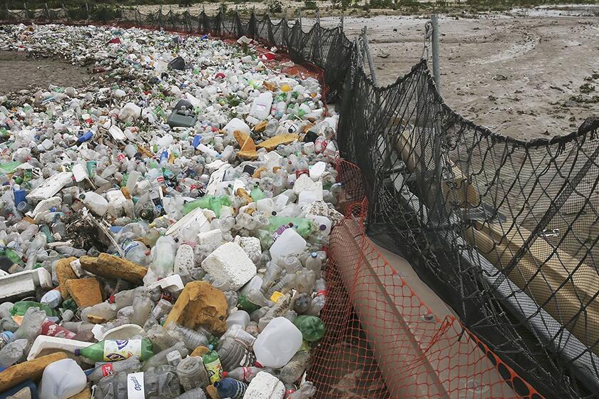 Debris gather in a catch basin on the U.S. side of the border in San Ysidro, Calif. When it rains, trash and raw sewage flow through the Tijuana River Valley to the Pacific Ocean.