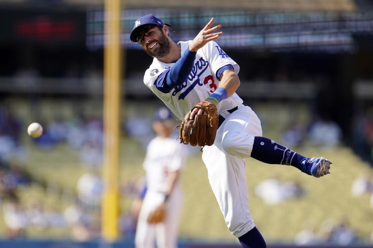 Dodgers second baseman Chris Taylor makes an off-balance throw to first base.
