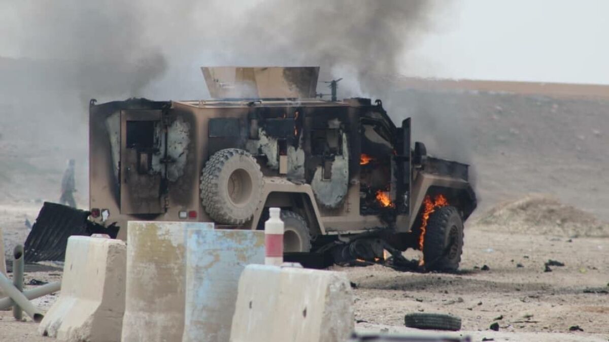 A photo obtained from Hawar News Agency shows a military vehicle at the scene of a suicide car bomb attack on a military convoy in northeastern Syria's Hasakah province. The attack killed five members of a Kurdish-led force accompanying U.S.-led coalition troops.