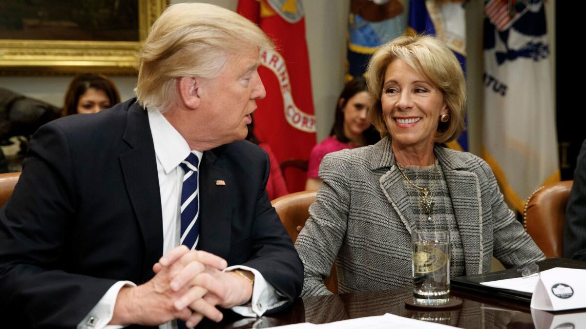 President Trump looks and Education Secretary Betsy DeVos at a meeting with parents and teachers in the Roosevelt Room of the White House on Feb. 14.