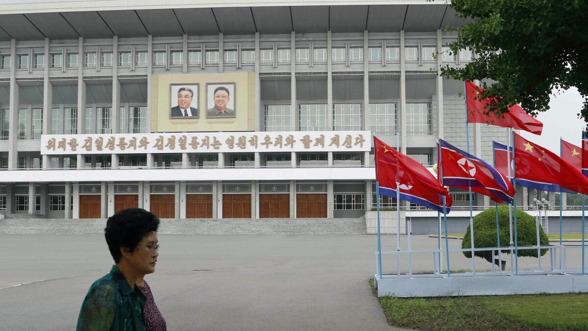 North Korean and Chinese flags are hoisted on a Pyongyang street Thursday.