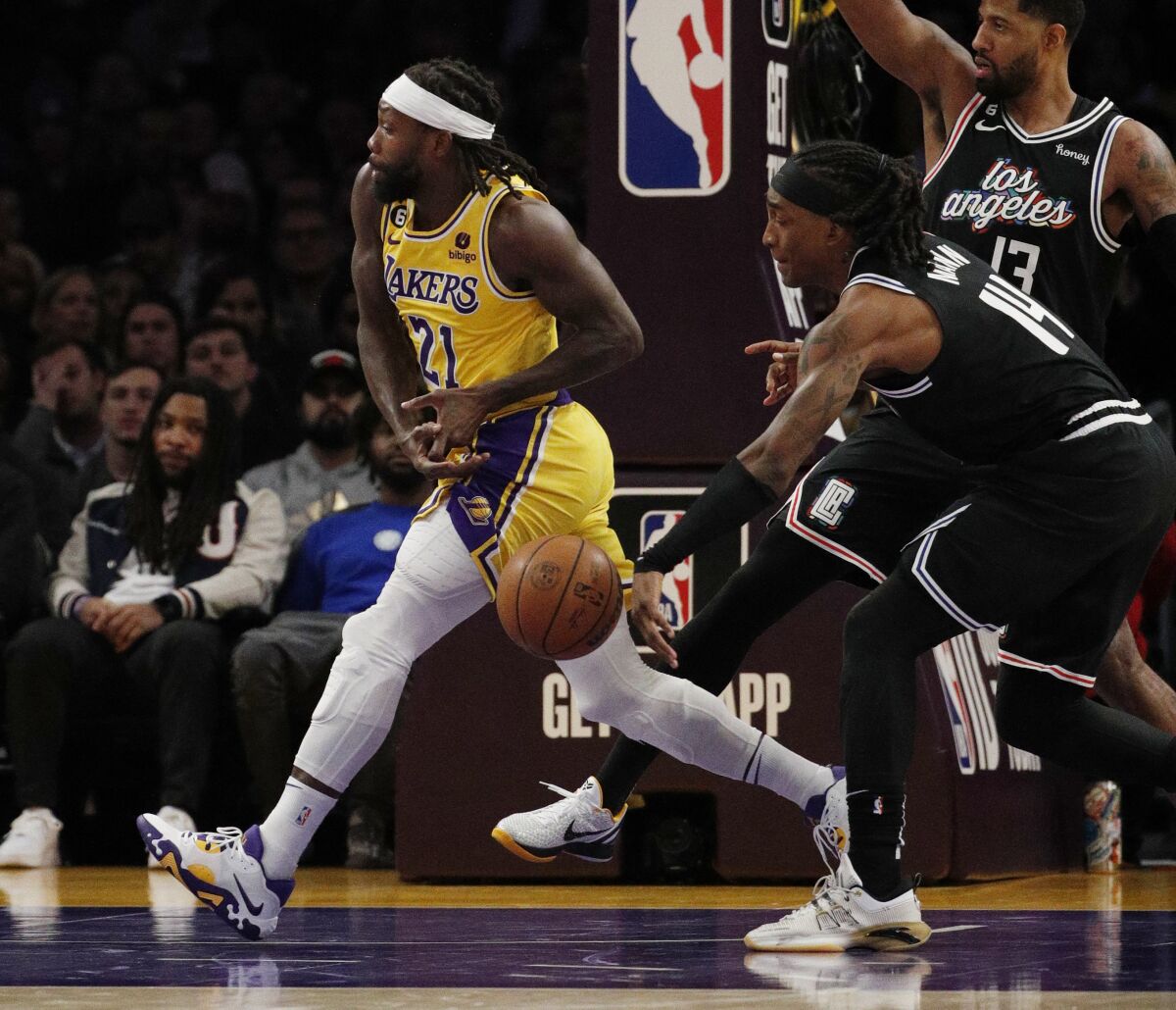 Clippers guard Terance Mann strips the ball from Lakers guard Patrick Beverley.