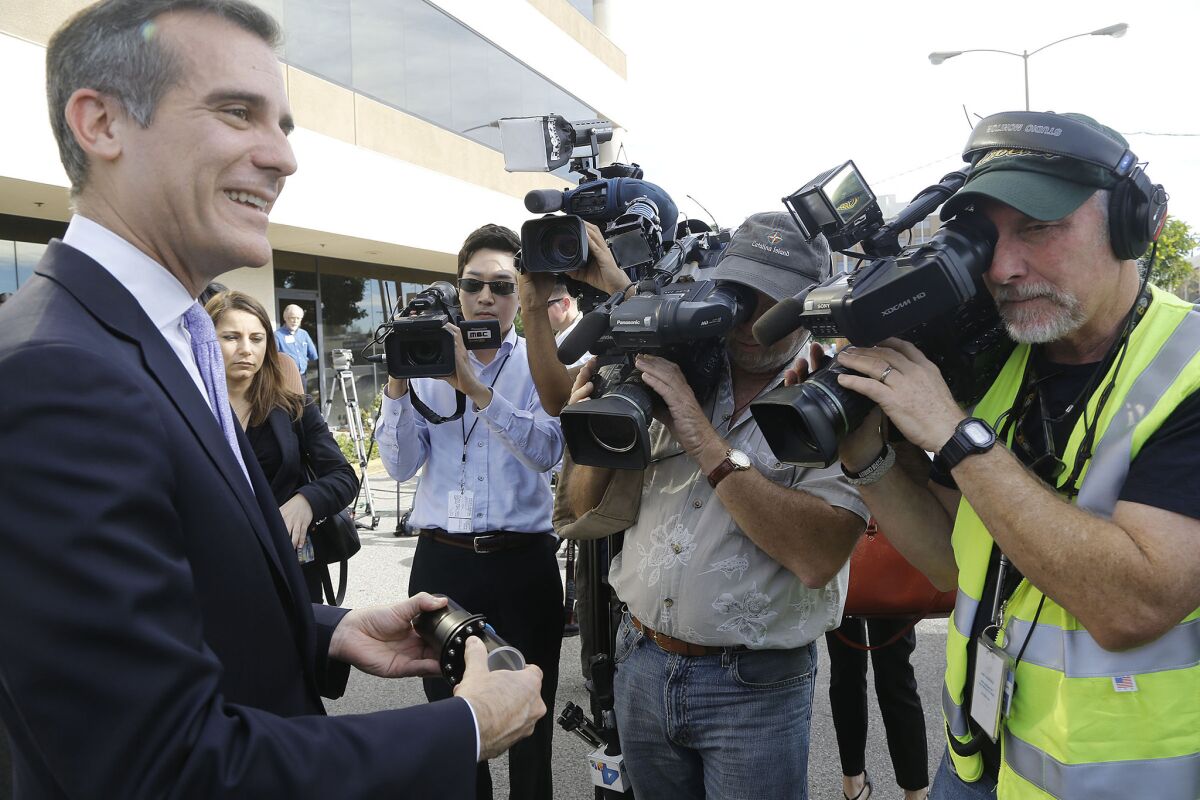 Los Angeles Mayor Eric Garcetti, holds a model joint of an earthquake-resistant ductile iron pipe during a Jan. 16 media event in Northridge.