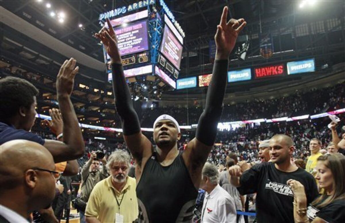 Atlanta Hawks forward Josh Smith reacts to the fans as he leaves the court after defeating the Miami Heat 91-78 in Game 7 of the Eastern Conference NBA basketball playoff series Sunday, May 3, 2009. (AP Photo/John Bazemore)