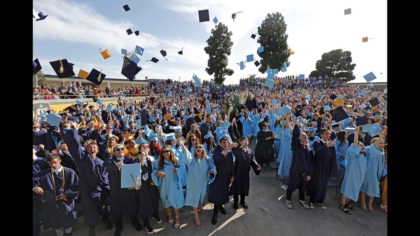 Graduates celebrate by tossing their caps into the air during the conclusion of Marina High School's commencement ceremony in Huntington Beach on Thursday, June 14.