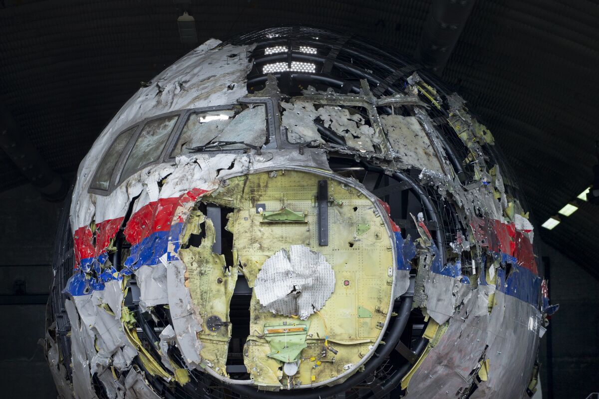 FILE- In this Wednesday, May 26, 2021, file photo the reconstructed wreckage of Malaysia Airlines Flight MH17, is shown at the Gilze-Rijen Airbase, southern Netherlands. The international team investigating the downing seven years ago of Malaysia Airlines flight MH17 over eastern Ukraine appealed Thursday for Russians in the city of Kursk to come forward with information about the deployment of the missile that the investigators say downed the plane, killing all 298 people on board. (AP Photo/Peter Dejong, File)