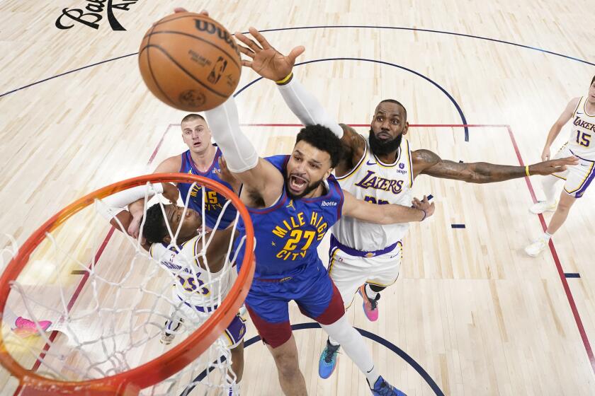 Denver Nuggets guard Jamal Murray (27) goes up to shoot against Los Angeles Lakers.
