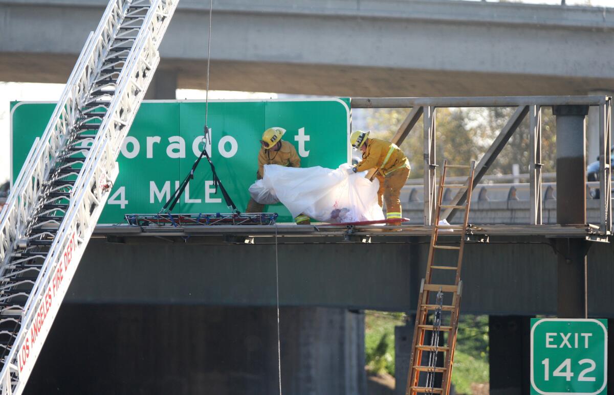 Southbound traffic on The Golden State (5) Freeway was diverted to the 134 freeway while Los Angeles City Fire Dept. personnel removed a body from a freeway sign in Glendale on Friday, Oct. 30, 2015. The body of the male driver was ejected from his vehicle during a traffic accident and thrown up onto the freeway sign.