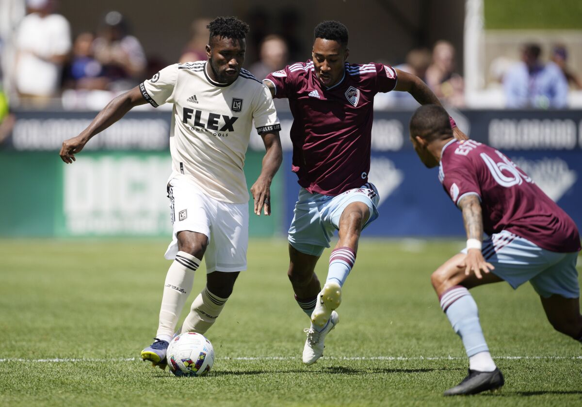 LAFC midfielder José Cifuentes dribbles against Colorado Rapids defenders Auston Trusty and Lucas Esteves.