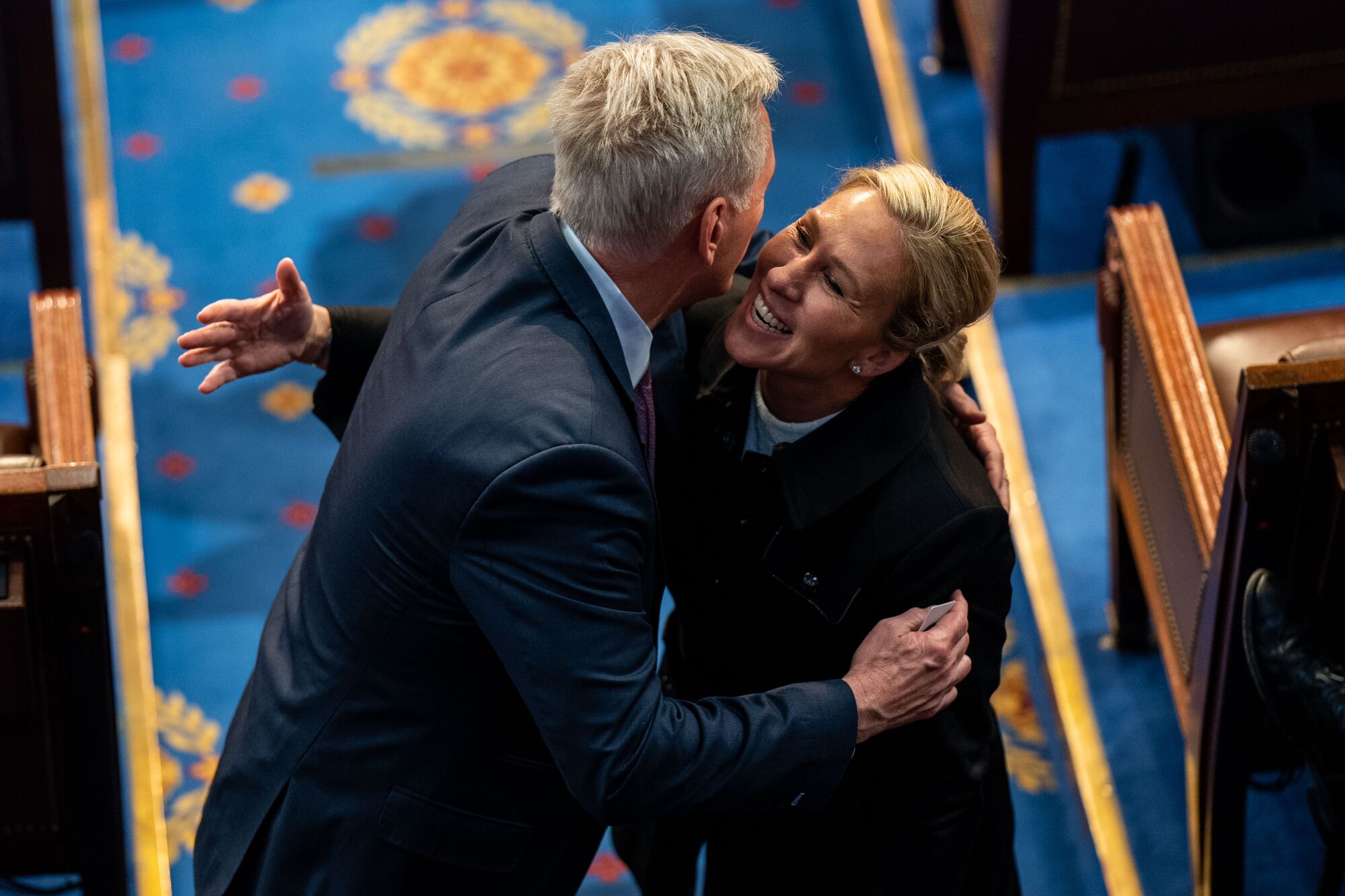  Kevin McCarthy hugs Rep. Marjorie Taylor Greene on the floor of the House Chamber Friday.