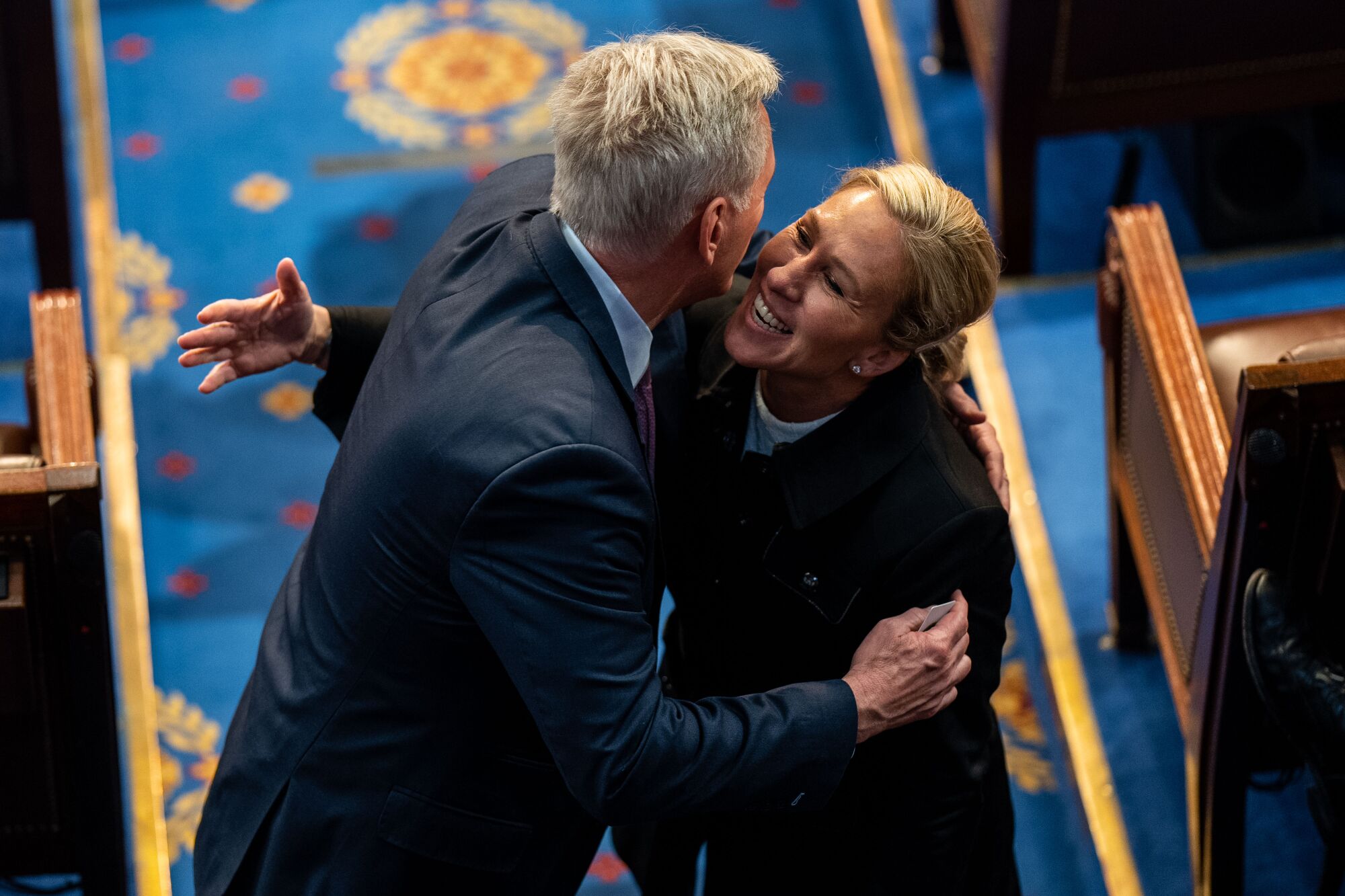 Kevin McCarthy hugs Rep. Marjorie Taylor Greene on the floor of the House Chamber Friday.