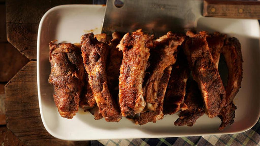 Tender baby back ribs are rubbed with a lightly sweet/lightly spicy dry rub and then smoked with hickory.