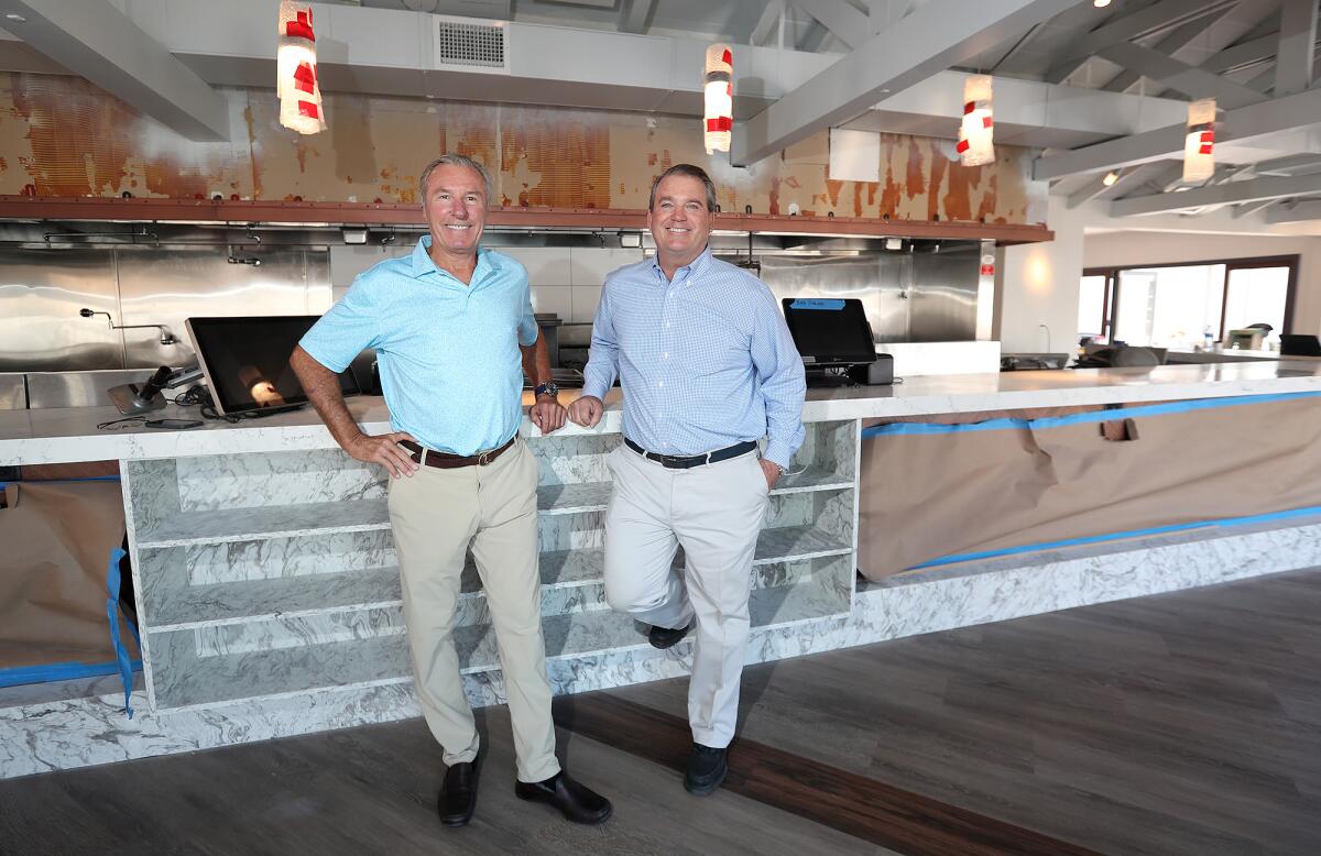 Co-founders Rick Staunton, left, and Jim Ulcickas, anticipate the re-opening of their Bluewater Grill in Newport Beach.