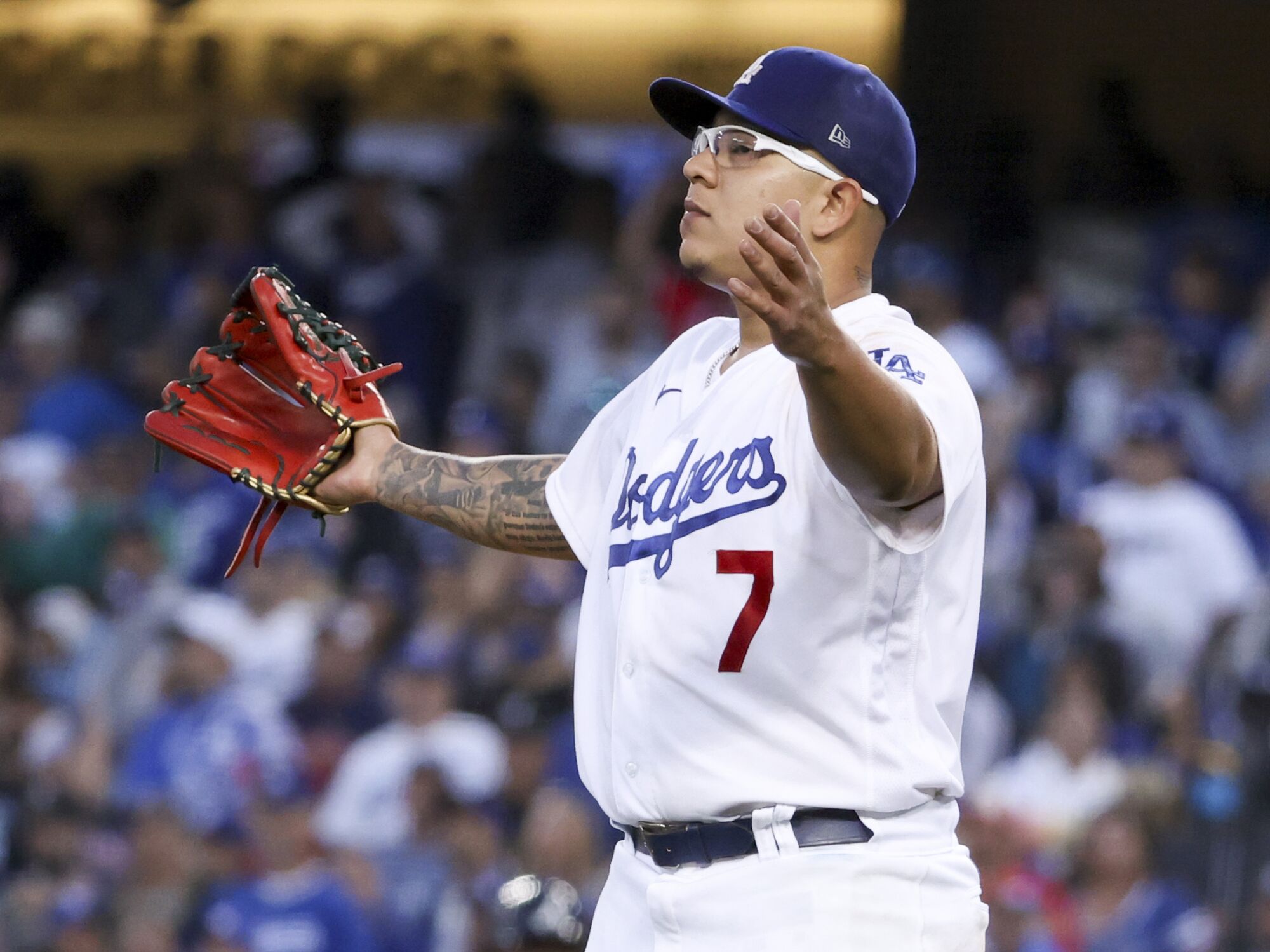  Dodgers pitcher Julio Urias reacts after an RBI single by Braves' Joc Pederson.