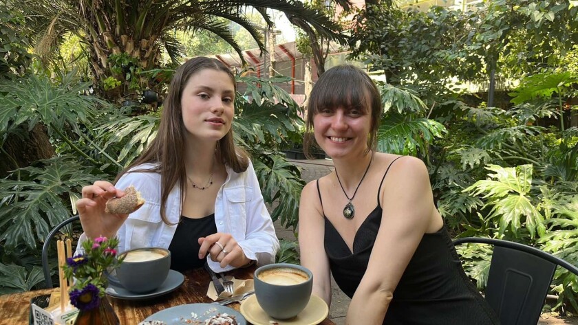 Yelyzaveta Krasulia (left) and Molly Surazhsky sit at a table in Mexico City