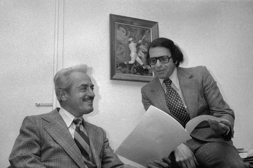 Marvin J. Miller, left, executive director of the Major League Baseball Players association and Richard Moss, general counsel of the association, discuss the organizations announcement that Oakland A?s pitcher catfish hunter is now considered a free agent. Hunter was not present at the announcement which was made in New York on Monday, Dec. 16, 1974. (AP Photo/Marty lederhandler)