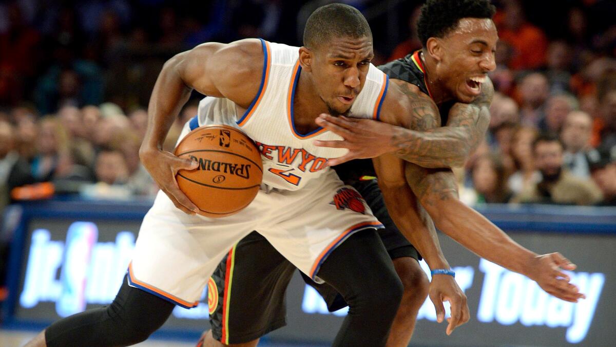 Knicks point guard Langston Galloway gets tangled with Hawks point guard Jeff Teague as he drives to the basket in the first half Thursday night.