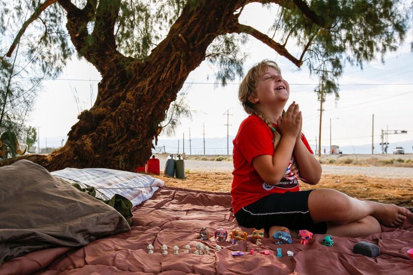 TRONA, CA - JULY 07, 2019 â Brooke Thompson, 8, plays on the sleeping bag that her family slept in after a pair of earthquakes drove them out of their home (Irfan Khan / Los Angeles Times)