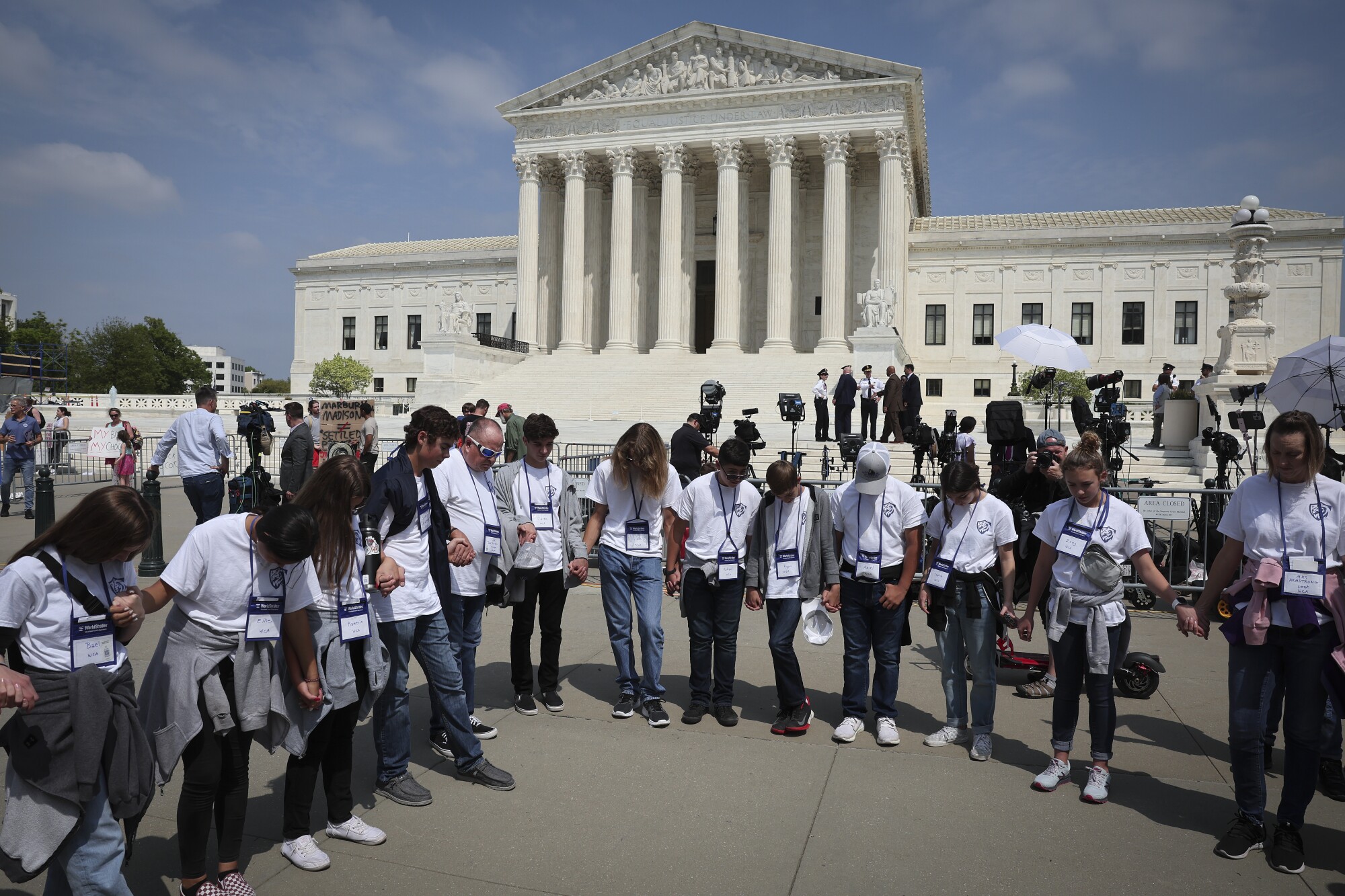 Students and parents from the Wickenberg Christian Academy, in Wickenberg, Arizona, pray in front of the U.S. Supreme Court 