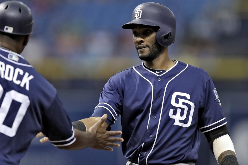 Alexei Ramirez is congratulated by first base coach Tarrik Brock after getting a single against the Rays during a Padres game Aug. 17.