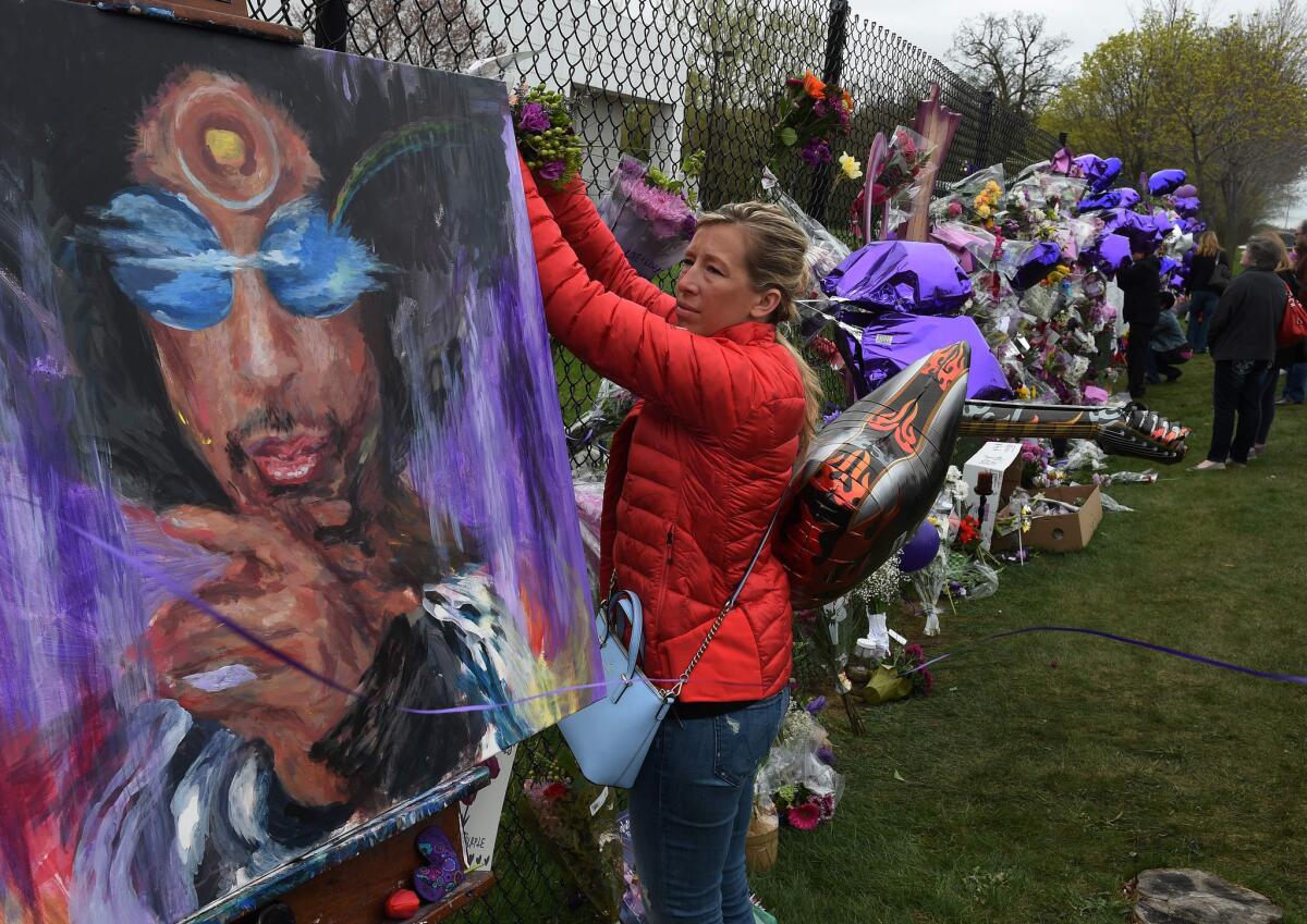 Prince's music is expected to remain the cornerstone of his estate. Above, a fan pays her respects Friday outside Prince's Paisley Park residential compound in Minneapolis.