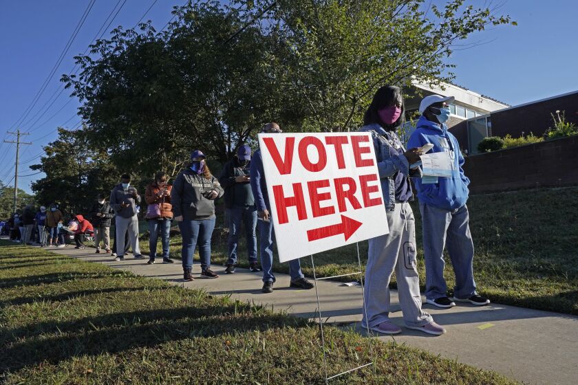 Early voters line up to cast their ballots at the South Regional Library polling location in Durham, N.C., Thursday, Oct. 15, 2020. (AP Photo/Gerry Broome)